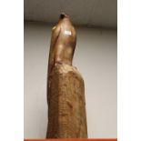 A TALL CARVED WOODEN FIGURE OF A PERCHED BIRD OF PREY