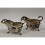 A PAIR OF SILVER PLATED SAUCE BOATS, makers marks for H & H, each raised on three outswept feet, W