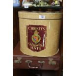 A CHRISTYS HAT BOX CONTAINING A TOP HAT AND BOWLER HAT, TOGETHER WITH A VINTAGE BRIEFCASE