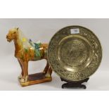 AN ORIENTAL STYLE BRASS PLATE WITH SIX CHARACTER MARK TO BASE TOGETHER WITH A TANG STYLE HORSE