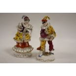 A PAIR OF CONTINENTAL STYLE CERAMIC FIGURES WITH CROSSED SWORD BACK STAMP