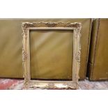 A 20TH CENTURY SWEPT GILT PICTURE FRAME REBATE - 51.5CM X 61.5CM