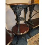 A PAIR OF WOODEN TOPPED CAST BASE CIRCULAR PUB TABLES H-70 DIA - 58 CM