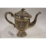 A WHITE METAL CONTINENTAL TEAPOT, decorated with two circular applied panels of an elephant with a