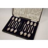 A CASED SET OF TWELVE GRAPEFRUIT TYPE SPOONS WITH A PAIR OF SUGAR TONGS BY LIBERTY & Co. GLASGOW