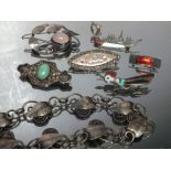 A COLLECTION A WHITE METAL JEWELLERY ITEMS, comprising six brooches, some marked Sterling silver,