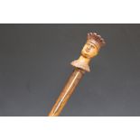 AN UNUSUAL CARVED WALKING STICK IN THE FORM OF A TOBACCONIST TYPE FIGURE, L 92 cm