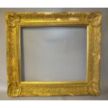 A 20TH CENTURY DECORATIVE GILT FRAME, with corner embellishments and modern gold slip, frame W 9 cm,