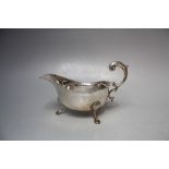 A SMALL HALLMARKED SILVER SAUCE BOAT - BIRMINGHAM 1940, raised on three outswept feet, L 14.5 cm