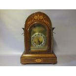 AN EDWARDIAN MAHOGANY INLAID MANTLE CLOCK WITH JUNGHANS MOVEMENT, the arched case with satinwood