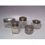 A COLLECTION OF SILVER LIDDED VANITY JARS, various dates and makers, to include a lidded salts jar