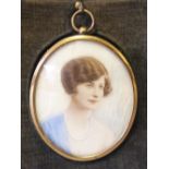 AN EARLY 20TH CENTURY OVAL PORTRAIT MINIATURE ON IVORY, young woman in blue dress and wearing a