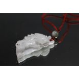 A JADE PENDANT IN THE FORM OF A DRAGON, W 5.5 cm