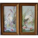 W. THOMAS. A pair of hand painted ceramic tiles of herons in the edges of lily clad ponds, signed