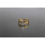 AN 18CT YELLOW GOLD DIAMOND SOLITAIRE RING, the illusion set diamond being an estimated 0.18ct, ring