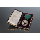 A VICTORIAN HALLMARKED SILVER VOLUNTEER OFFICERS MEDAL BY R & S GARRARD & CO - LONDON 1897, on green