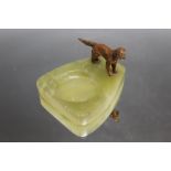 A COLD PAINTED BRONZE DOG ON ONYX DISH, D 10 cm