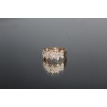 A DIAMOND CLUSTER RING, set with twenty five brilliant cut diamonds, ring size R 1/2