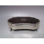 A GEORGIAN HALLMARKED SILVER SHAPED JEWELLERY BOX - BIRMINGHAM 1919, raised on four outswept feet,