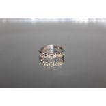 AN 18 CARAT WHITE GOLD FIVE STONE DIAMOND RING, set with an estimated diamond weight of 0.56