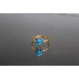 AN 18 CARAT YELLOW GOLD DYED HOWLITE AND DIAMOND RING, the Howlite being an estimated 6mm round,