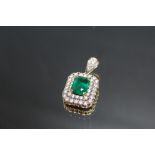 AN EMERALD AND DIAMOND ART DECO PENDANT, set with a central emerald cut emerald of an estimated 3.