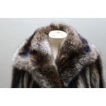 A LADIES VINTAGE LONG LENGTH RACOON FUR COAT BY FAULKES OF EDGBASTON, with black suede bow