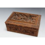 A CHINESE SANDALWOOD BOX, with carved figures to lid, W 21.5 cm