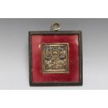 A RUSSIAN STYLE RELIGIOUS ICON, with traces of enamelling, framed and glazed, frame W 10.5 cm