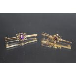 A HALLMARKED 9 CARAT GOLD AMETHYST BROOCH, W 4.5 cm together with a similar ruby type stone set