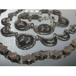 TWO SIAM SILVER AND BLACK ENAMEL NECKLACES, each comprised of six smaller plaques and a large
