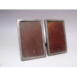 A PAIR OF SMALL RECTANGULAR HALLMARKED SILVER PICTURE FRAMES - BIRMINGHAM 1927, easel back,