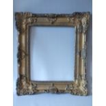 A LATE 19TH / EARLY 20TH CENTURY GILT SWEPT FRAME, frame W 120 cm, rebate size 40 x 33 cm