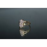 A HALLMARKED 9 CARAT GOLD RING, set with lilac and clear stones, ring size N 1/2