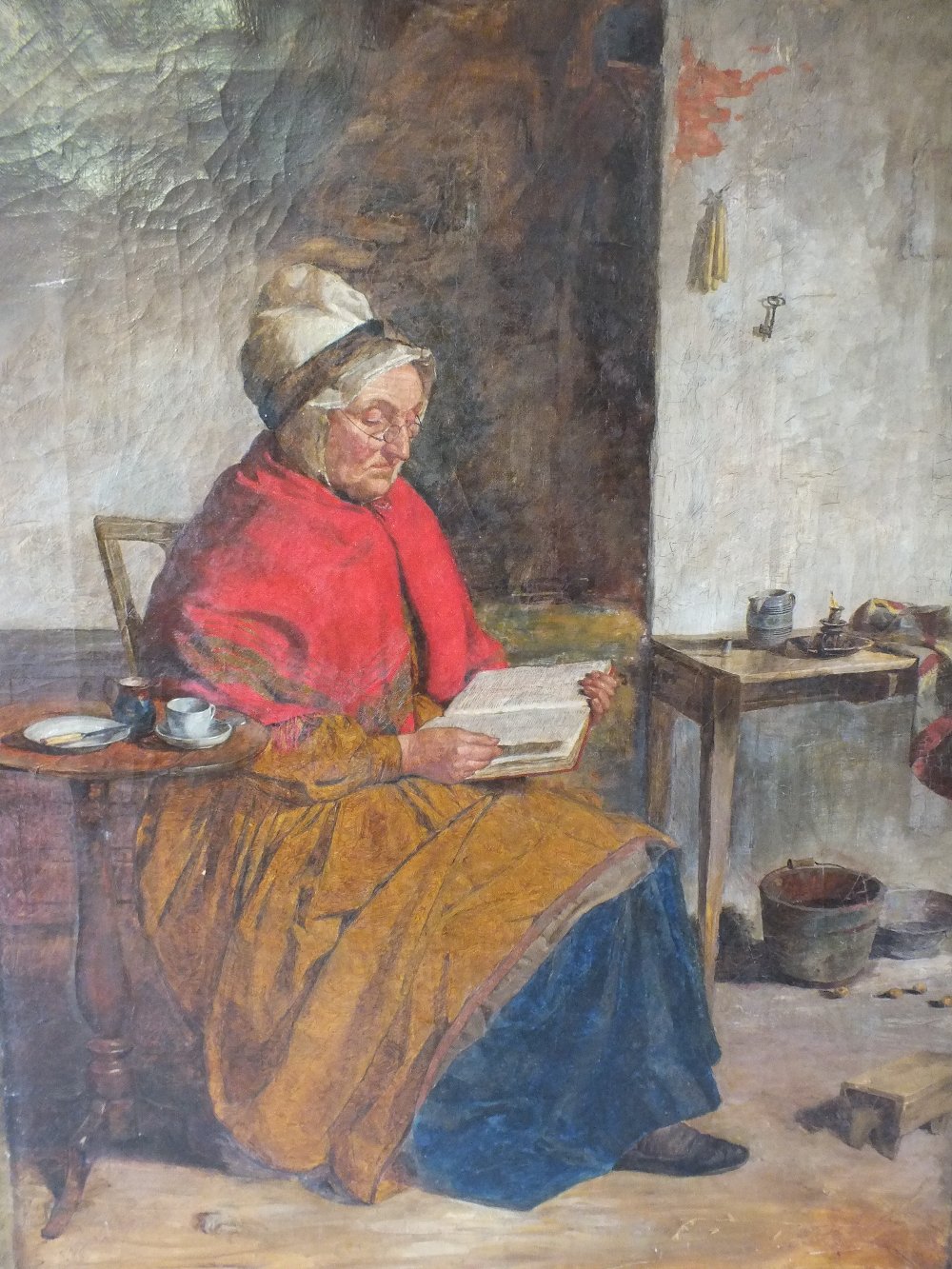 (XIX). British school, cottage interior with seated lady reading a book, unsigned, oil on canvas,