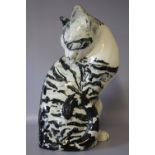A. SHORT (XX). Ceramic study of a seated cat washing itself, signed and inscribed underneath 'Studio