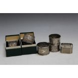 FOUR ASSORTED HALLMARKED SILVER NAPKIN RINGS, together with two 90% silver examples (6)