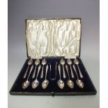 A CASED SET OF TWELVE GRAPEFRUIT TYPE SPOONS WITH A PAIR OF SUGAR TONGS BY LIBERTY & Co. GLASGOW