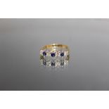 AN 18 CARAT YELLOW GOLD SAPPHIRE AND DIAMOND RING, set with three sapphires totalling an estimated