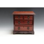 AN EDWARDIAN STYLE MINIATURE MAHOGANY CHEST OF DRAWS, with lion mask handles, W 31 cm