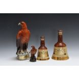TWO BELL'S WHISKY SEALED CERAMIC DECANTERS, together with a Beswick Beneagles 'Golden Eagle'