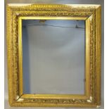 A 19TH CENTURY DECORATIVE GILT FRAME WITH INTEGRAL SLIP, frame W 14 cm, rebate size 68 x 56 cm
