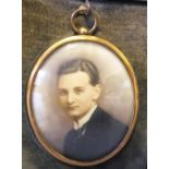 AN EARLY 20TH CENTURY OVAL PORTRAIT MINIATURE ON IVORINE, young gentleman in black jacket and