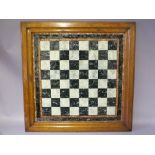 A 19TH CENTURY FOLK ART REVERSE PAINTED GLASS CHESS BOARD, in original oak framed, 60 x 60 cm