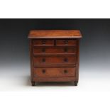 A MAHOGANY MINIATURE TWO OVER THREE CHEST OF DRAWS, H 38.25 cm