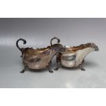 A PAIR OF SILVER PLATED SAUCE BOATS, makers marks for H & H, each raised on three outswept feet, W