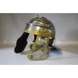 A 20TH CENTURY ROMAN STYLE WHITE METAL HELMET, with neck and side flaps, interior measurement 20 x