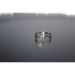 A DIAMOND SOLITAIRE RING, the central brilliant cut diamond of a good colour is an estimated quarter