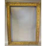 A 19TH CENTURY DECORATIVE GILT FRAME, frame W 7 cm, rebate size 79 x 56 cm