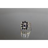 AN 18K WHITE GOLD SAPPHIRE AND DIAMOND RING, set with ten oval sapphires totalling an estimated 1